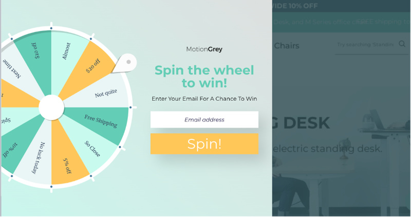 alt="MotionGrey spin-to-win popup showing discount percentages on a prize wheel with email entry form.